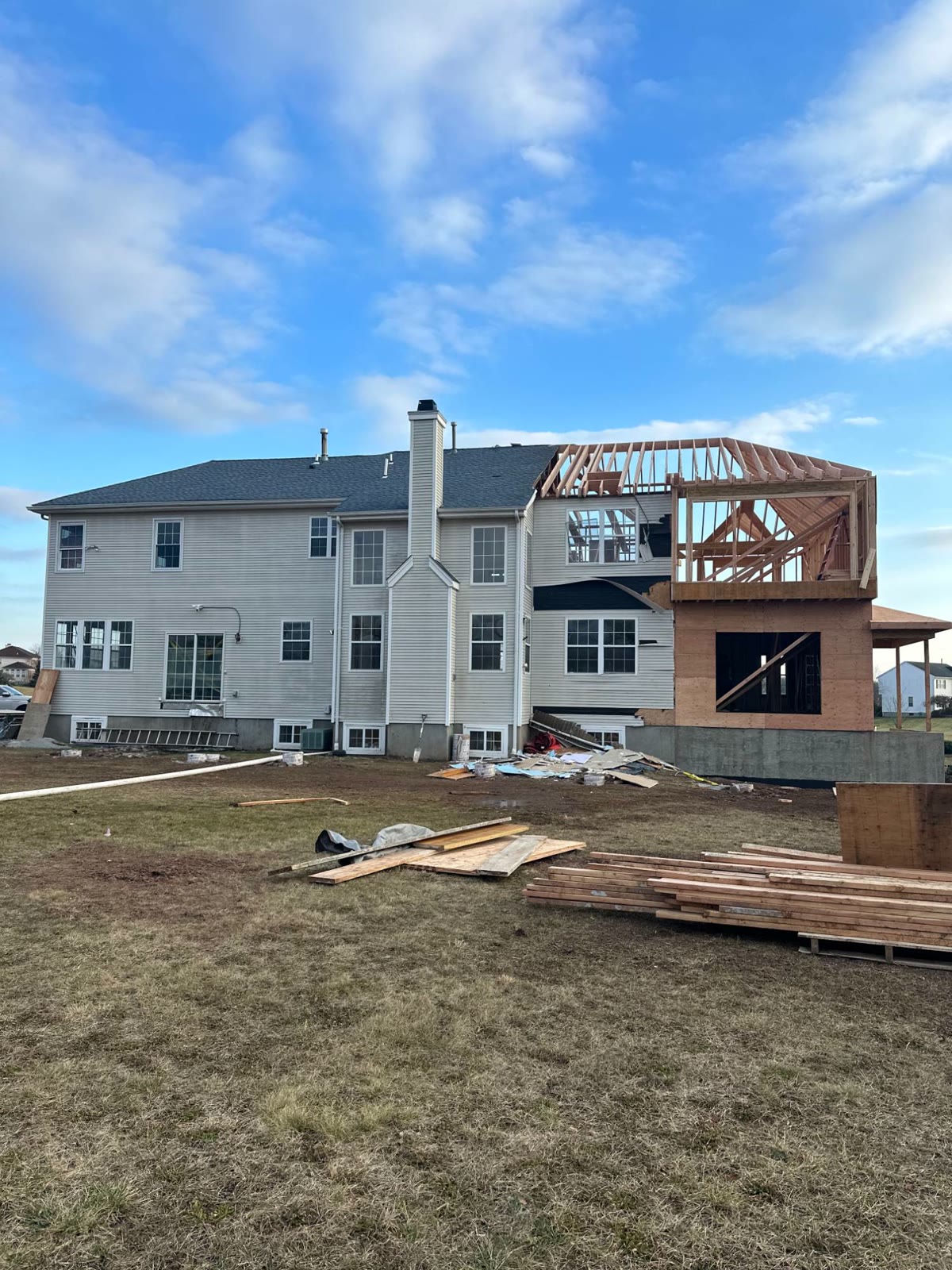 The rear of the house showing the addition's new foundation and framing