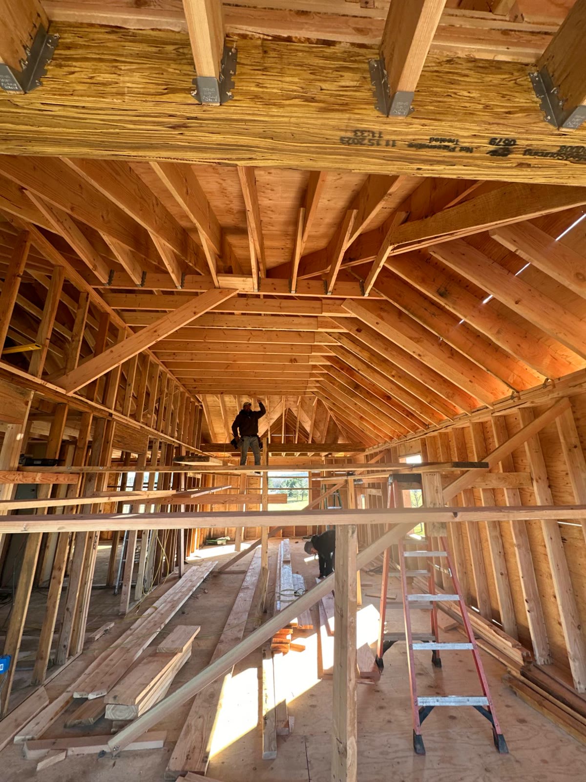 Crew working inside the new roof framing