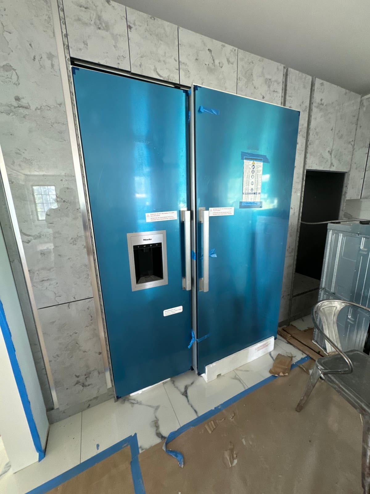 Built-in refrigerator and freezer set into the new cabinetry