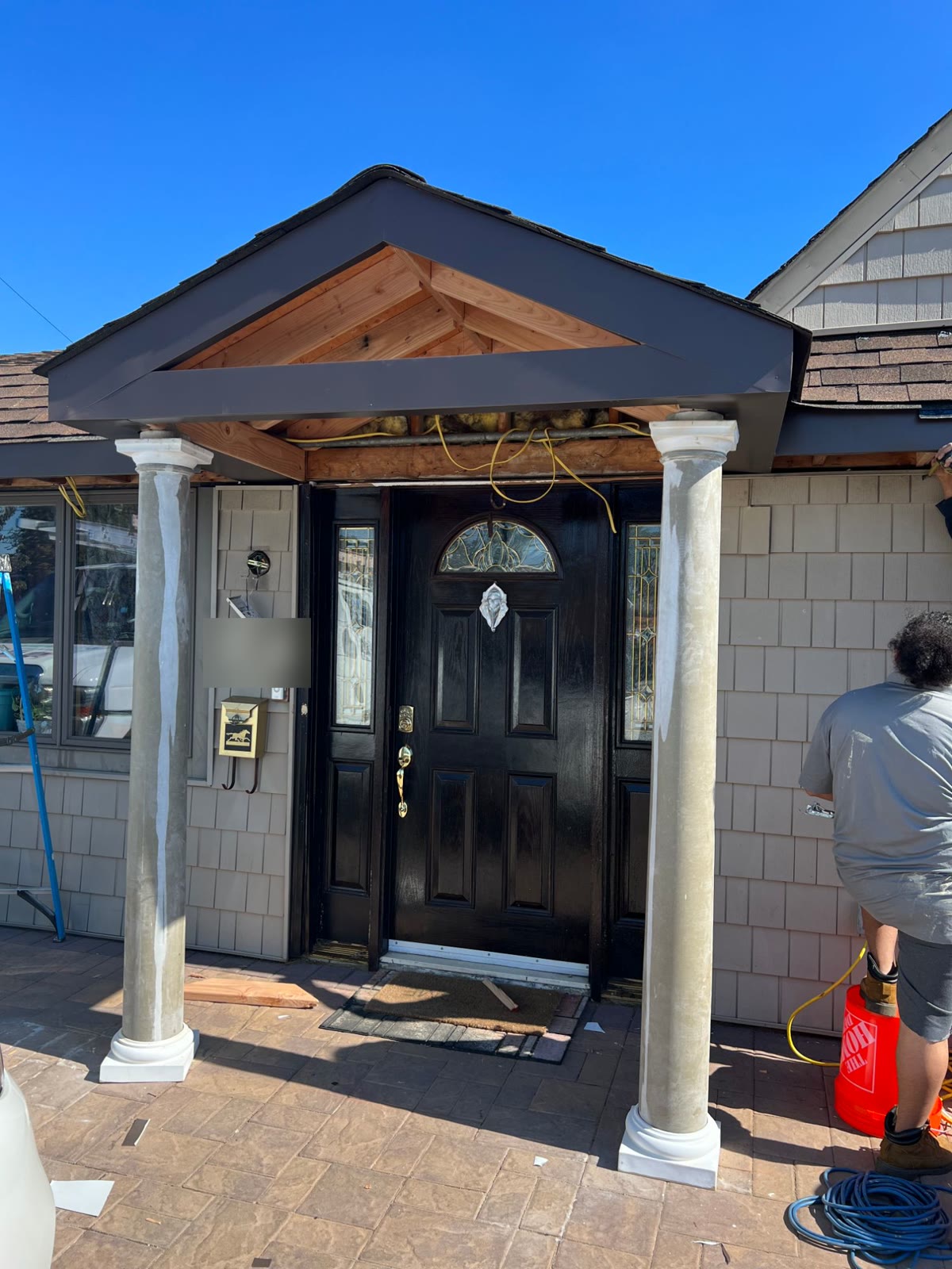 Home renovation: a new front portico with columns over the entry door